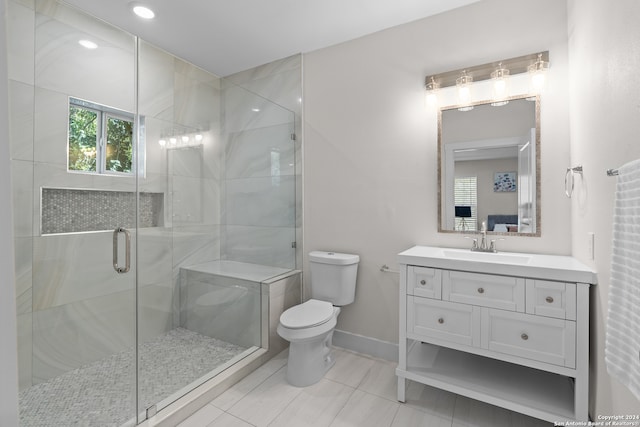 bathroom featuring walk in shower, tile patterned flooring, vanity, and toilet