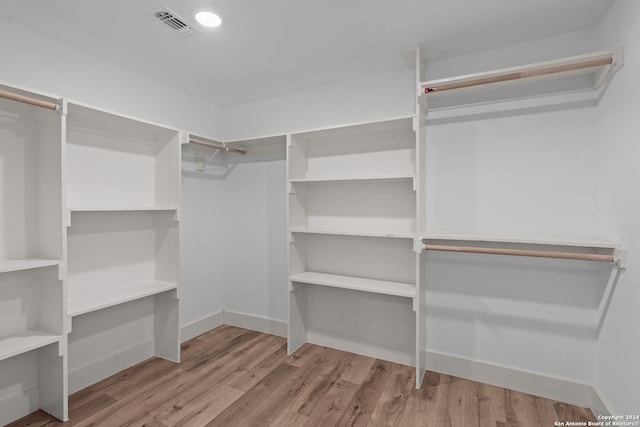 walk in closet featuring light hardwood / wood-style flooring