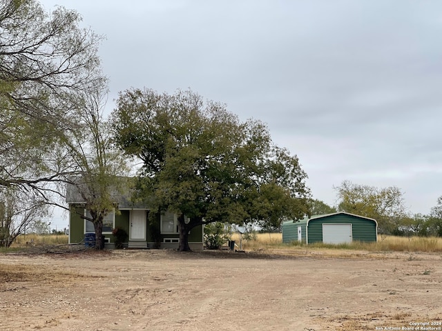 4235 Mickey Rd, San Antonio, TX 78223 - view of front facade with a garage, an outbuilding, and driveway