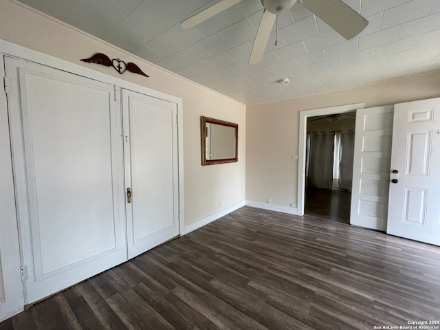 unfurnished bedroom featuring dark hardwood / wood-style floors and ceiling fan