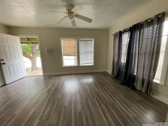 unfurnished room with ceiling fan and dark hardwood / wood-style flooring