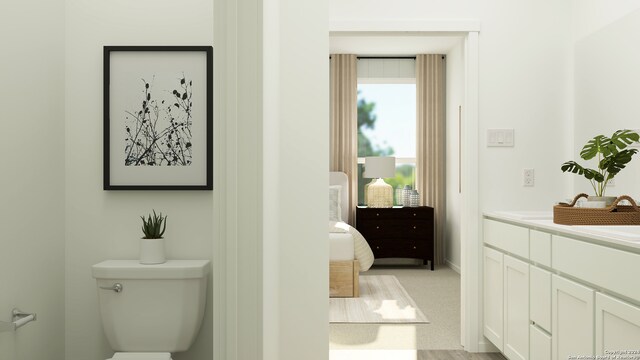 bathroom featuring wood-type flooring, vanity, and toilet