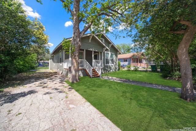 bungalow-style home with a porch and a front lawn