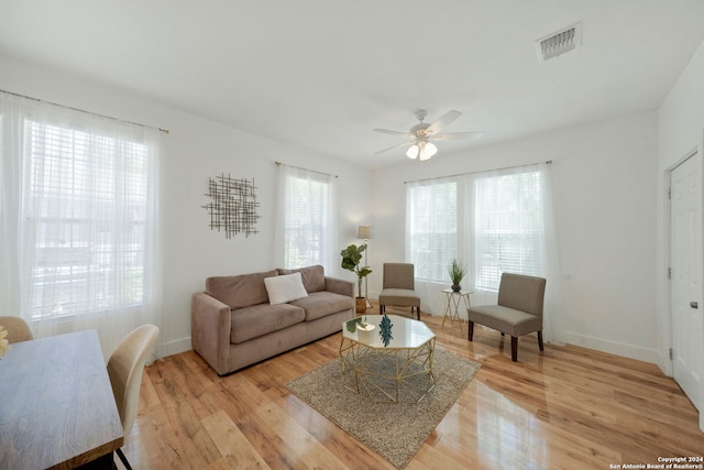 living room with ceiling fan and light wood-type flooring