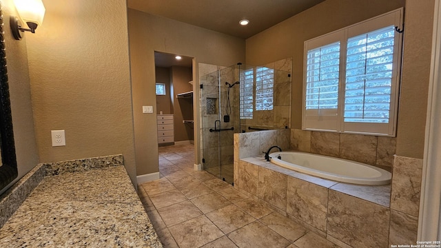 bathroom with a shower stall and a bath