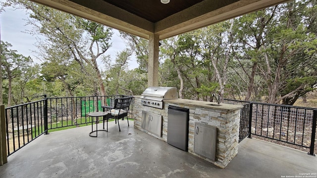 view of patio with a balcony, a sink, and area for grilling