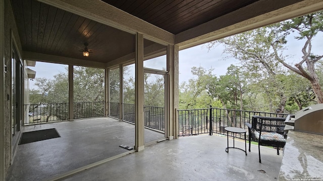 sunroom / solarium with ceiling fan and wood ceiling