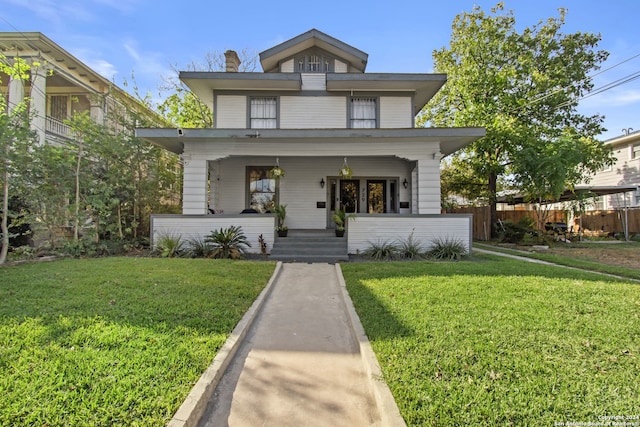 view of front of house with a porch and a front lawn