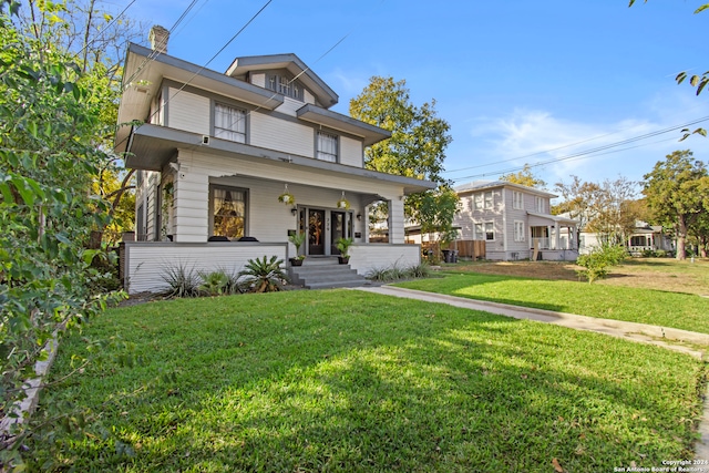 view of front of property with a porch and a front lawn