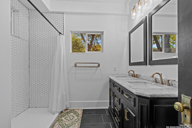 bathroom with tile patterned flooring, vanity, and walk in shower