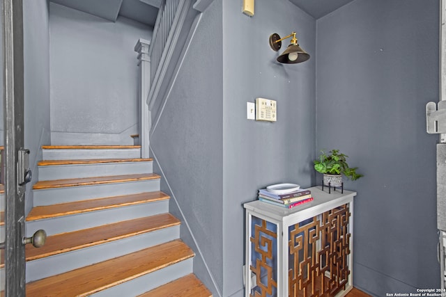 stairs featuring hardwood / wood-style floors