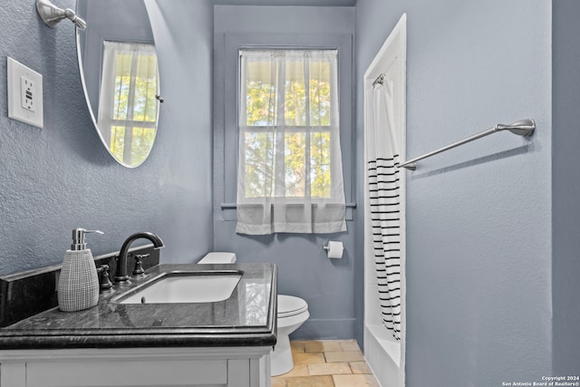 bathroom with plenty of natural light, vanity, and toilet