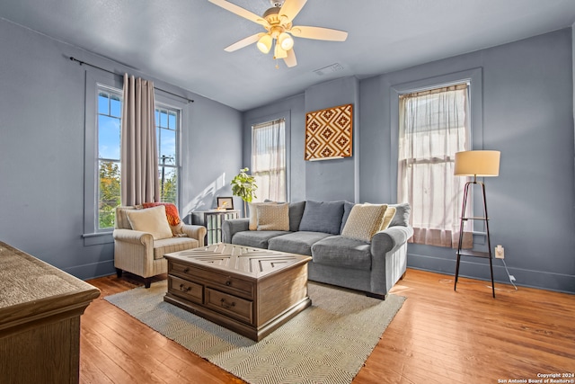 living room with ceiling fan and light hardwood / wood-style floors