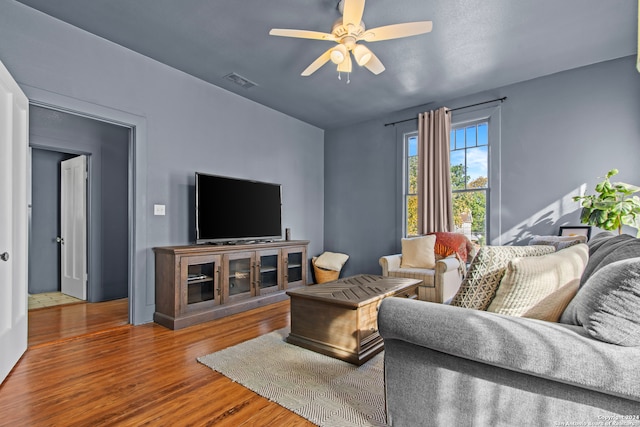 living room featuring hardwood / wood-style flooring and ceiling fan