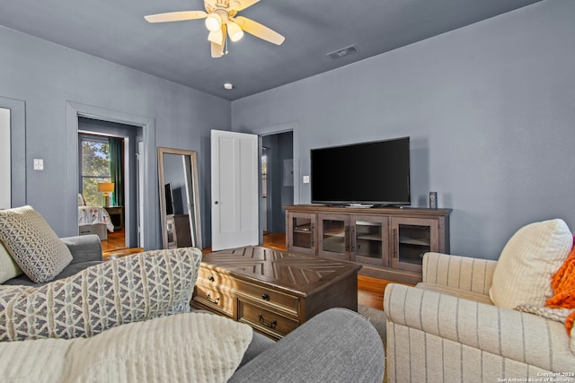 living room featuring hardwood / wood-style flooring and ceiling fan