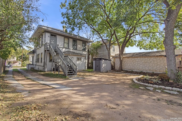 view of front of home with a shed