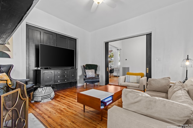 living room with hardwood / wood-style flooring and ceiling fan