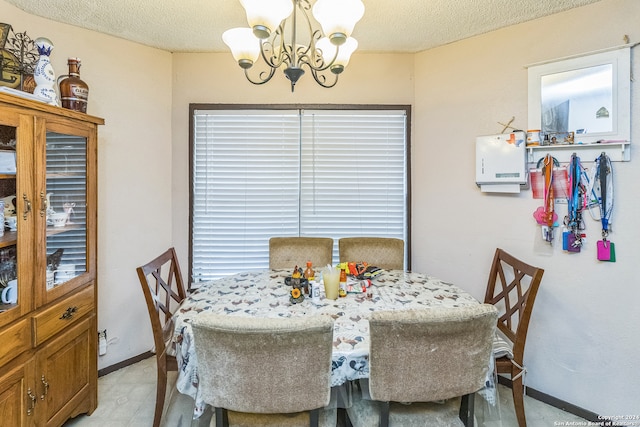 dining room with a notable chandelier and a textured ceiling