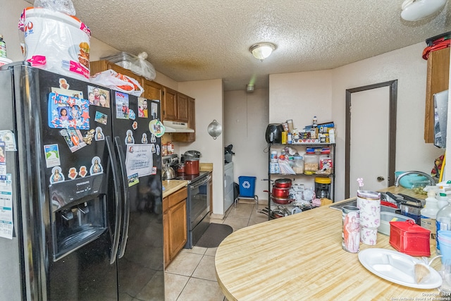 kitchen with sink, black range with electric cooktop, stainless steel refrigerator with ice dispenser, a textured ceiling, and light tile patterned floors