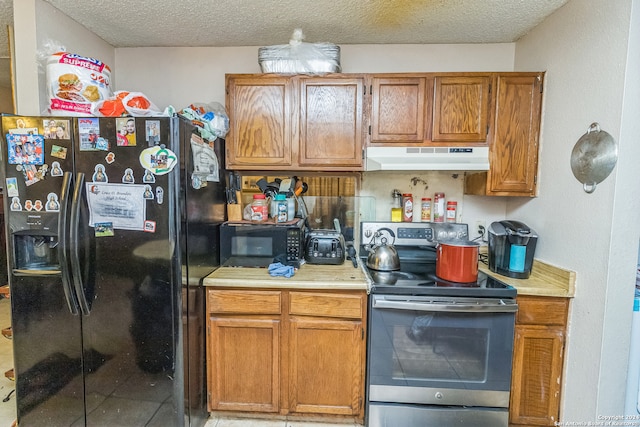 kitchen with a textured ceiling and black appliances