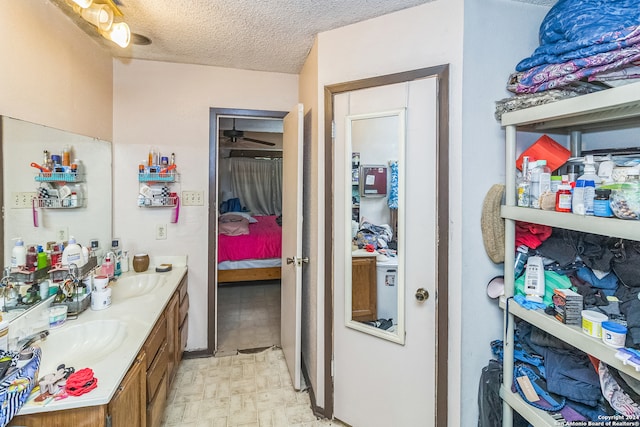 bathroom with vanity and a textured ceiling