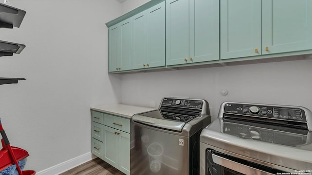 222 Sigel Ave, New Braunfels, TX 78132 - washroom featuring cabinet space, washing machine and clothes dryer, wood finished floors, and baseboards