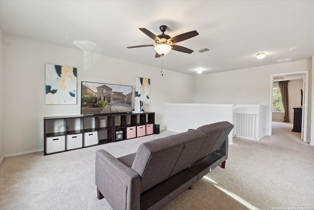 carpeted living room featuring ceiling fan