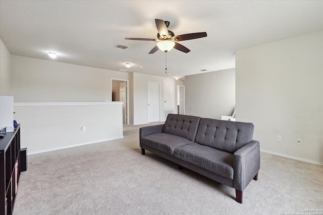 carpeted living room with ceiling fan