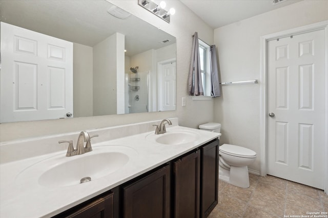 bathroom with a shower, vanity, and toilet