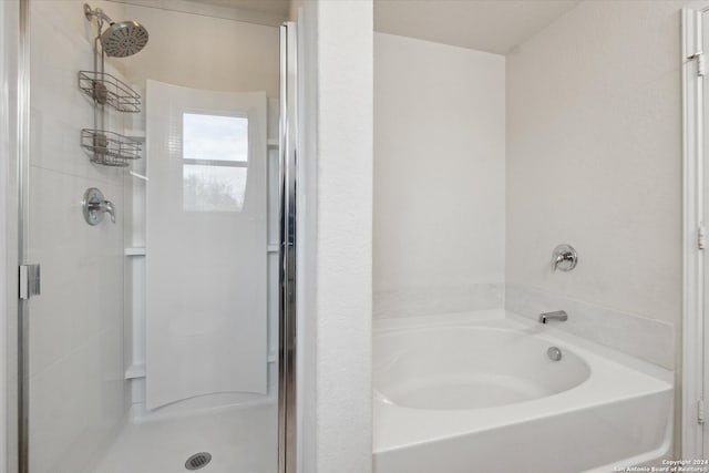 bathroom with shower with separate bathtub