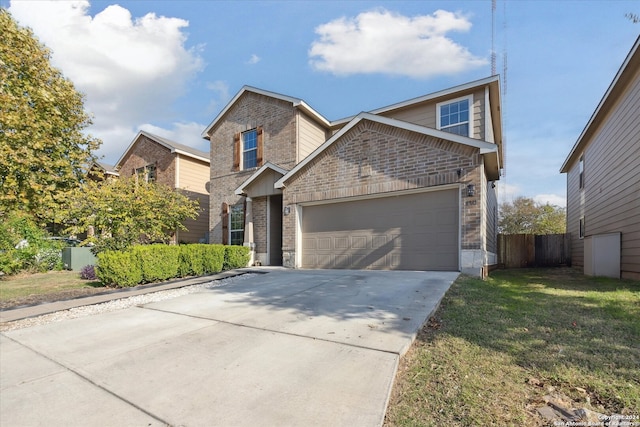 view of front of property with a garage and a front lawn