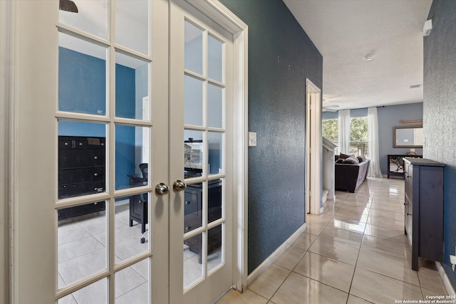 corridor with tile patterned flooring and french doors