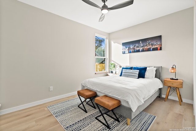 bedroom with light hardwood / wood-style flooring and ceiling fan