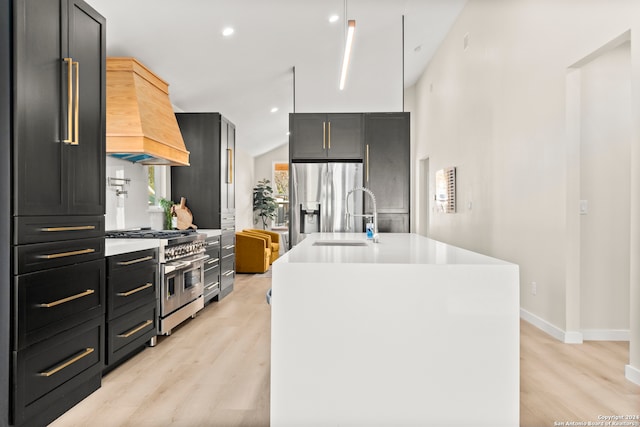 kitchen featuring a kitchen island with sink, sink, custom exhaust hood, and appliances with stainless steel finishes