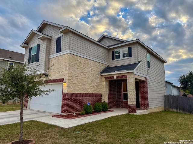 craftsman-style home featuring a garage and a front lawn