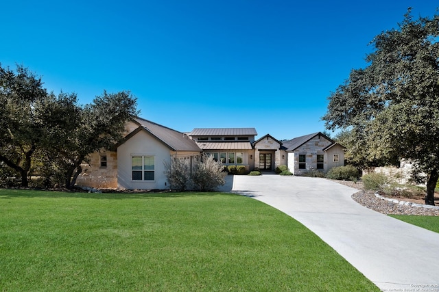 view of front of home with a front yard and french doors