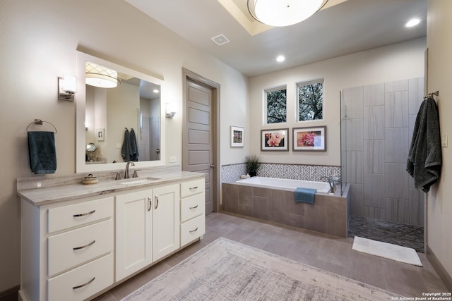 bathroom featuring vanity and shower with separate bathtub