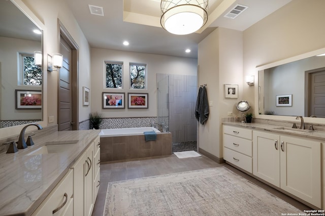 bathroom featuring plus walk in shower and vanity