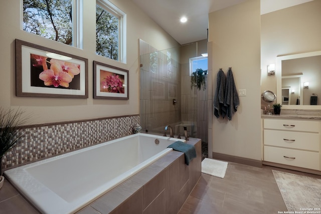 bathroom featuring tile patterned flooring, vanity, and shower with separate bathtub