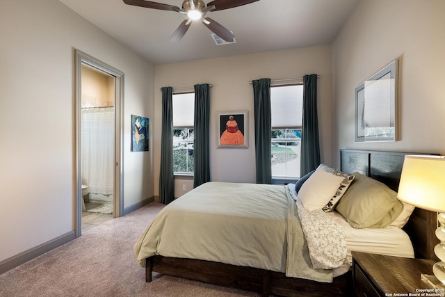 bedroom with ensuite bathroom, ceiling fan, and light colored carpet