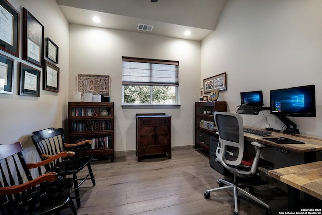 office space with light hardwood / wood-style flooring