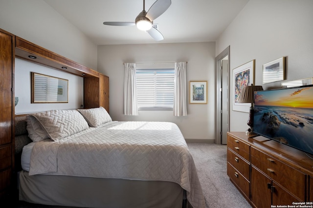 bedroom featuring light colored carpet and ceiling fan