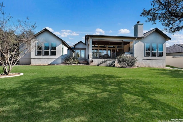 rear view of property featuring a yard and a porch