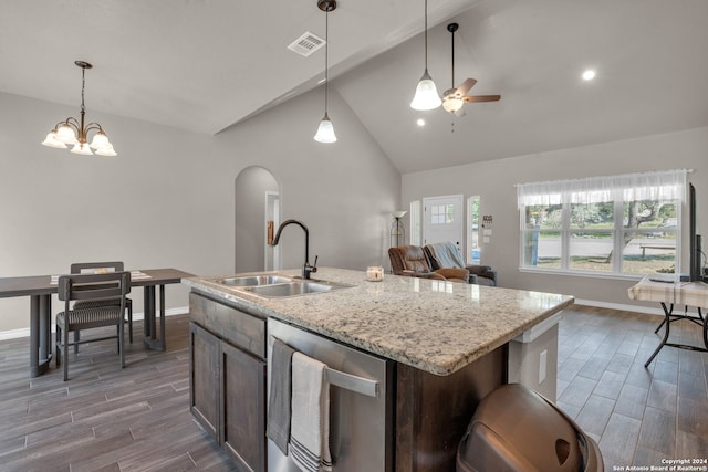 kitchen with sink, stainless steel dishwasher, hardwood / wood-style floors, a kitchen island with sink, and ceiling fan with notable chandelier