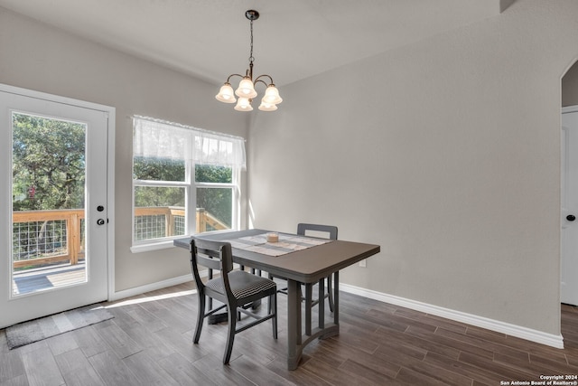 dining area featuring dark hardwood / wood-style flooring and a chandelier