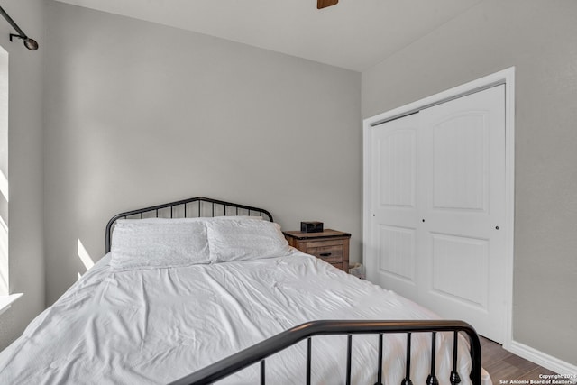 bedroom with hardwood / wood-style floors and a closet