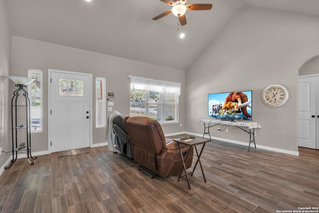 living room with ceiling fan, high vaulted ceiling, and dark hardwood / wood-style floors