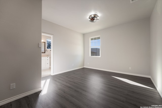 empty room with dark hardwood / wood-style flooring