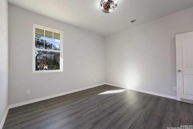 unfurnished room with dark hardwood / wood-style floors