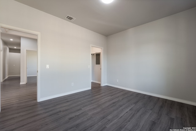 unfurnished room featuring dark wood-type flooring